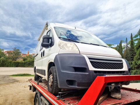 Tow truck carrying a broken down camper van