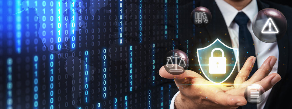 Businessman holding glowing shield with a padlock icon, surrounded by legal scales, warning signs, document folders, and binary code, representing data protection. Concept of Data Privacy Enforcement - Powered by Adobe