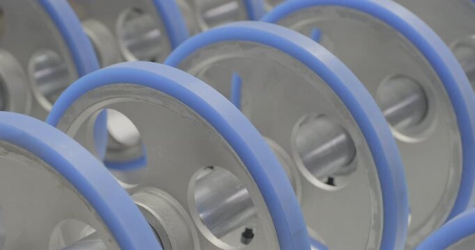 The conveyor is working, the rollers are rotating. Handheld shot, real time speed, artificial lighting.