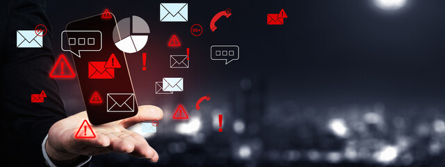 Mobile security threat, warning sign on a smartphone held in a hand against a blurred cityscape background. Showing the risk of data breach or malware infection. Concept of Information Overload