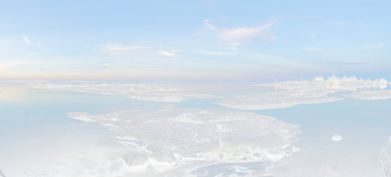 Panoramic view of land patches amidst sea against sky