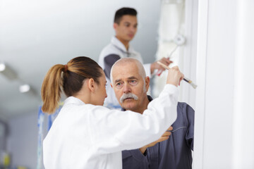 Fototapeta premium woman painting with teacher in workshop