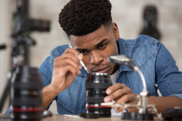 technician repairing a camera lens
