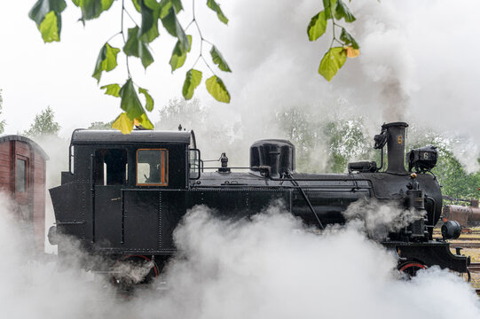 View of steam train releasing smoke
