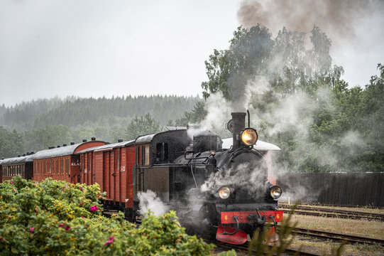 View of old steam train on track against sky