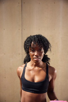 Portrait of female athlete with curly hair