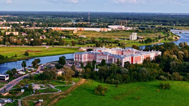 Aerial view of Jelgava city with Lielupe river and historic palace on golden hour sunlight