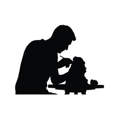 Silhouette of a father and child interacting over a tabletop activity