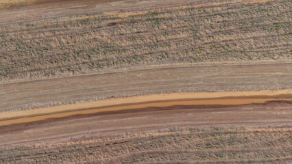 Aerial View of Barren Landscape with Tire Tracks