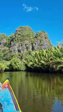 ​Scenic Boat Trip on Calm River Water with Green Karst Landscape
