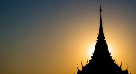 A majestic silhouette of a traditional temple spire against a vibrant sunset, showcasing intricate architectural details and the warm glow of the fading day