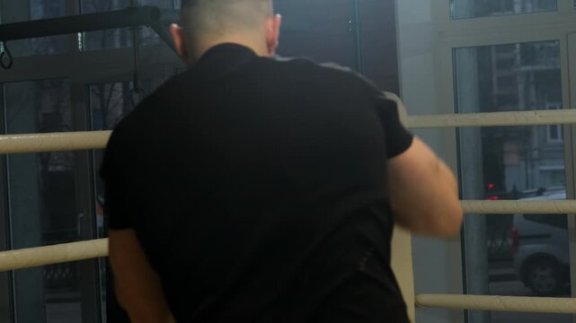 Boxer shadowboxes professionally to hone punching skills in ring. Athlete trains reaction simulating real situation in fight against opponent