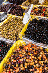 Marinated olives in containers at a stall at a Provençal food market in France