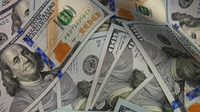 Elegant visual sweep moving across dimensional waves of hundred dollar bills arranged as banknotes that illustrate investment stability and create an exclusive polished impression of money abundance