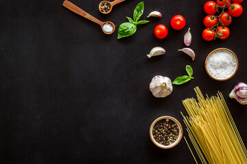 Food ingredients for cooking Italian pasta with tomatoes and basil leaves, top view