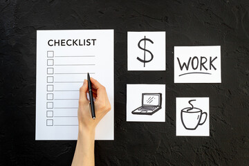 Hand writes in Checklist and many paper cards with hand drawing of different life activities, top view. Life balance and planning concept.