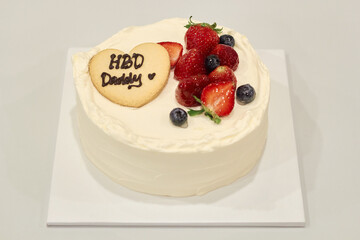 Cream birthday cake with strawberries