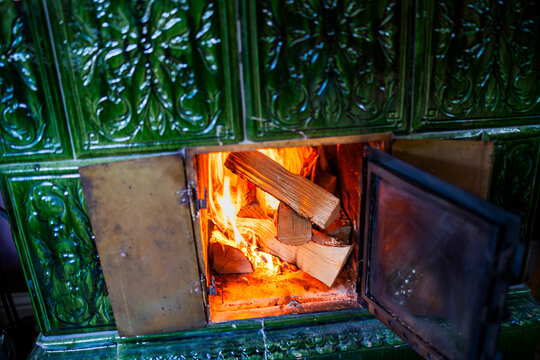 High angle view of wood log burning in fireplace between mantelpiece