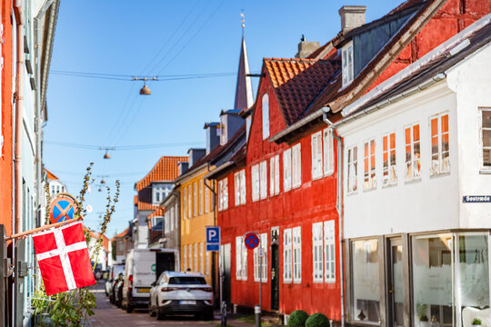 Denmark flag at street with buildings under clear sky