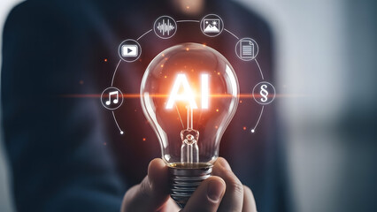 Hands holding a glowing lightbulb surrounded by digital technology icons