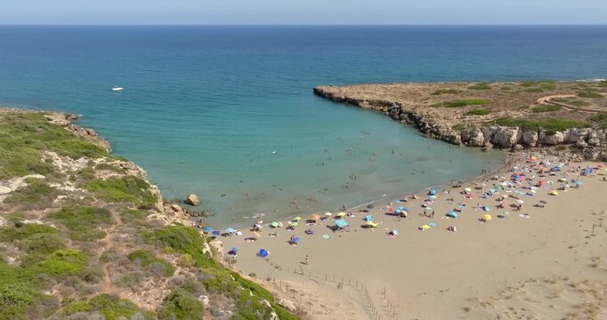 Aerial panoramic view of Cala Mosche (or Calamosche) beach, a beautiful sandy beach within the Vendicari Nature Reserve, near Noto, Sicily, Italy. It's famous for its crystal clear and blue waters.