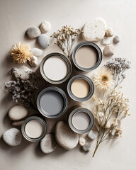 Mood board flat lay aesthetic open paint cans in soft neutral colors beige taupe grey white surrounded by dried flowers pebbles and smooth natural stones interior design color palette inspiration.