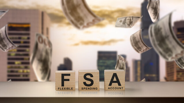 Wooden blocks spelling out FSA (Flexible Spending Account) with money falling around, suggesting financial planning or healthcare savings. Concept of FSA