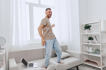 Happy man dancing at home, enjoying a digital detox and embracing work-life blur, showcasing authentic imperfection in solo living and mental health awareness.