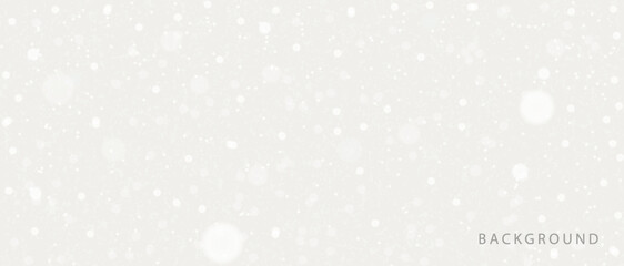 Abstract background with soft light highlights and bokeh on a light gray background. A texture with shimmering particles that creates a snow or star effect. Perfect for festive, New Year, winter.
