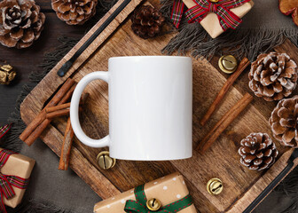 White coffee mug 11oz near Christmas presents and wooden decor, atmospheric mockup, top view