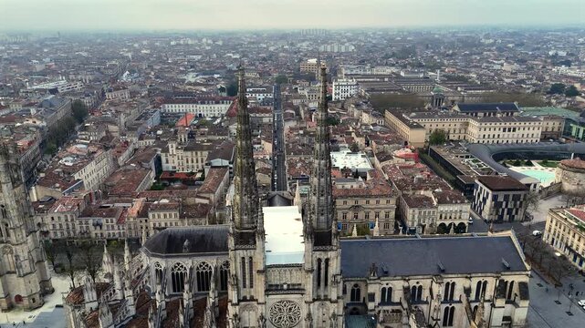 Aerial fly through Pey Berland twin spires into Bordeaux narrow street