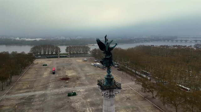 360 degree drone orbit of Monument aux Girondins statue and boulevards in fog