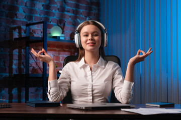 Woman Meditating at Office Desk with Headphones