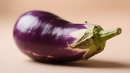 A close-up of an eggplant from the side with a blurred background