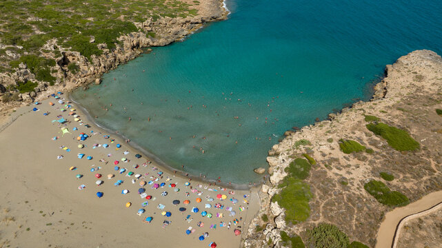 Aerial view of Cala Mosche (or Calamosche) beach, a beautiful sandy beach within the Vendicari Nature Reserve, near Noto, Sicily, Italy. It's famous for its crystal clear and blue waters. Sunny day.