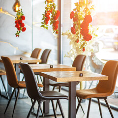 A beautifully designed restaurant interior showcasing a modern and elegant dining area. The space features contemporary furniture, including wooden chairs and tables set with glassware, plates.
