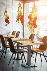 A beautifully designed restaurant interior showcasing a modern and elegant dining area. The space features contemporary furniture, including wooden chairs and tables set with glassware, plates.