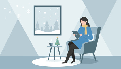 Fototapeta premium Woman reading tablet by window on cozy winter day Christmas tree hot drink indoor comfort