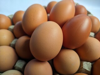 Close Up of Farm Fresh Brown Eggs Stacked in a Carton