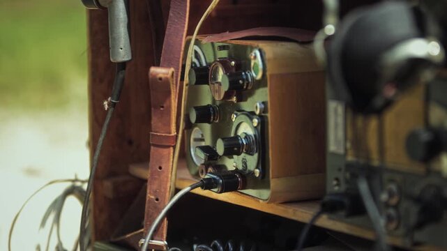Close-up of vintage Soviet field radio station, Red Army communication equipment. Knobs, dials, and wires visible. Display at Great Patriotic War exhibition.