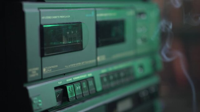 Starting Playback of Audio Cassette Tape in Old Double Deck Player Recorder, Cigarette Smoke, Close Up