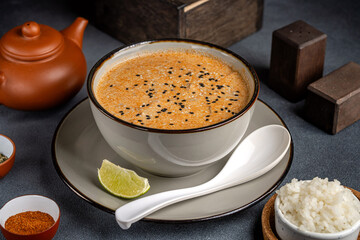 Creamy sesame soup with rice and lime