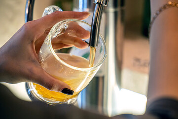 Fresh draft beer pouring into glass