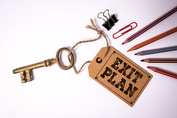 Exit Plan Concept With Vintage Key And Office Supplies On White Background