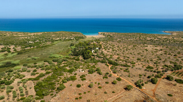 Aerial view of Cala Mosche (or Calamosche) beach, a beautiful sandy beach within the Vendicari Nature Reserve, in province of Syracuse, Sicily, Italy. It's famous for its crystal clear and blue sea.