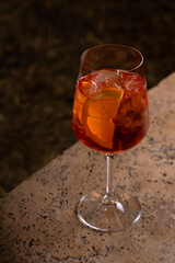 Aperol spritz cocktail in a glass on a stone table
