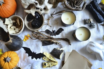 Autumn flat lay with pumpkins, candles, bats, and natural elements for halloween