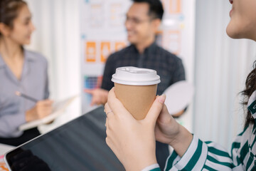 UX/UI designers collaborating during a creative workshop to test interface ideas and exchange feedback for app development, emphasizing teamwork and innovative design thinking.