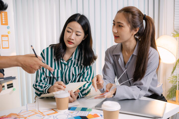 UX/UI designers presenting their final design project to the team, showcasing app interface screens and explaining user experience strategies in a professional creative office environment.