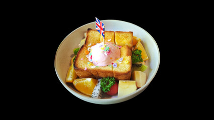Honey toast on a plate with sweet fruits A delicious dessert with ice cream and toast on Black background.